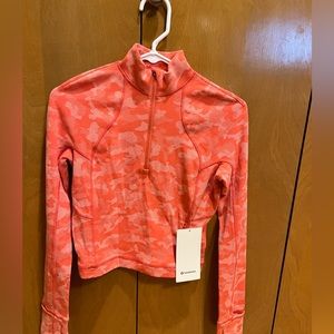 Lululemon cropped half zip. Coral color. New with tags. Super cute color.